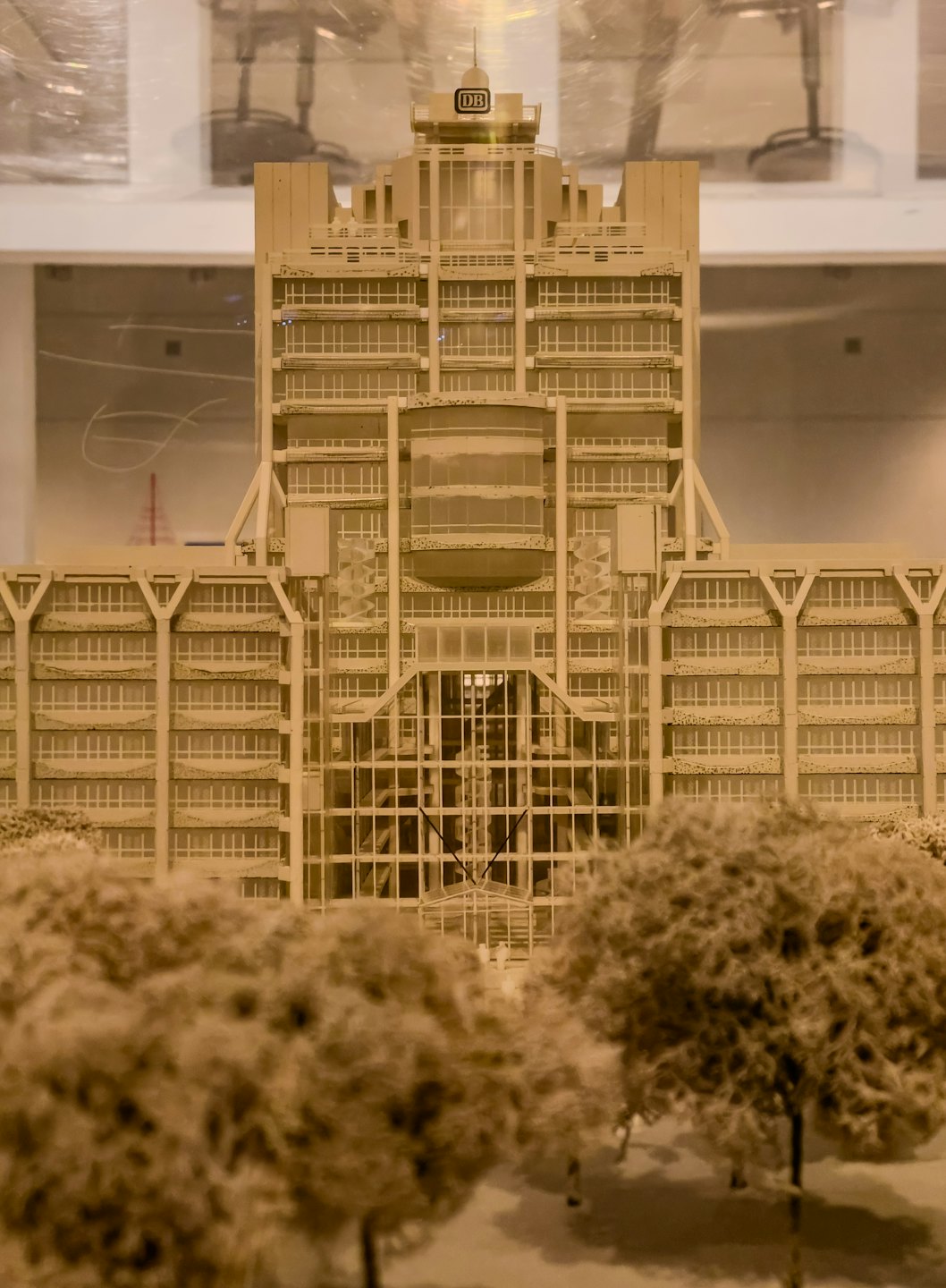 Intricate beige architectural model of a multi-story building with 'DB' logo.